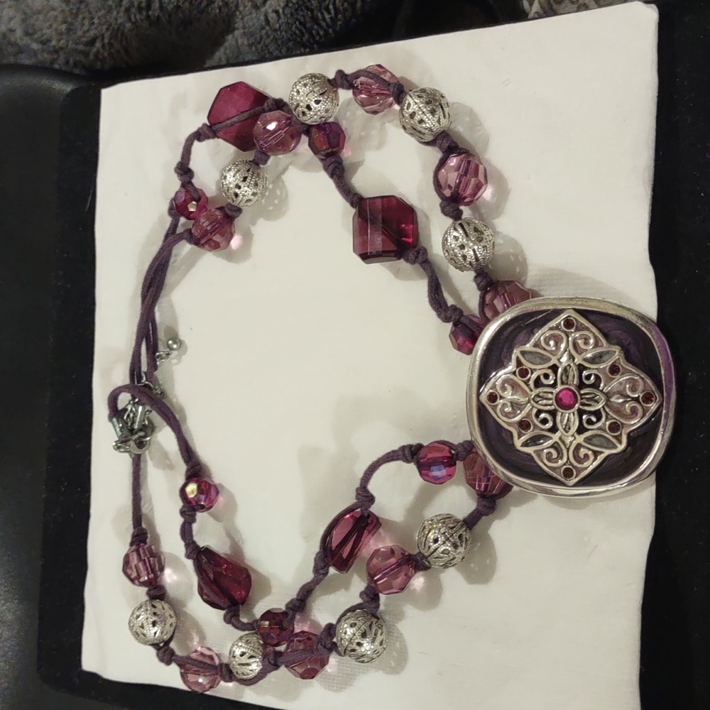 PURPLE AND SILVER TONED BEADS ATTACHED TO A LARGER CENTER PENDANT